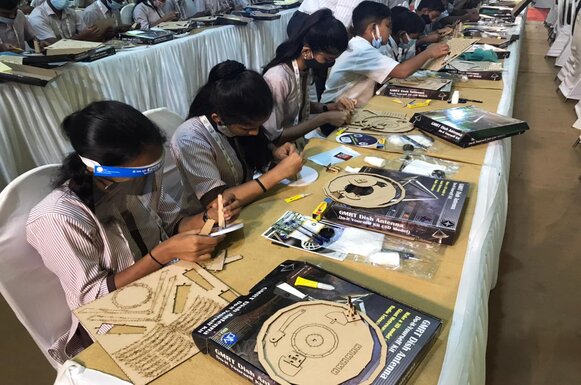 Students assembling paper dish antenna