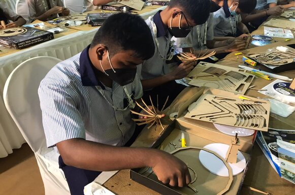 Students assembling paper dish antenna